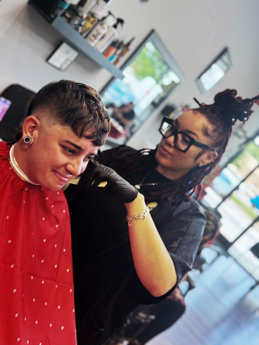 A Razor Republic barber cutting a client's hair in the shop